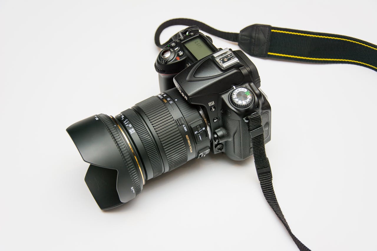 team-01 Close-up of a DSLR camera with a lens and strap, ideal for photography equipment themes.